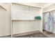Spacious walk-in closet with wooden rods, shelving, and stack of neatly folded towels at 14124 W Bent Tree S Cir, Litchfield Park, AZ 85340