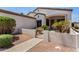 Charming entryway with gate provides access to a landscaped front yard with mature plants and a covered porch at 14124 W Bent Tree S Cir, Litchfield Park, AZ 85340