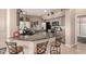 Eat-in kitchen features granite countertops, stainless steel appliances, breakfast bar, and plenty of cabinet space at 14124 W Bent Tree S Cir, Litchfield Park, AZ 85340