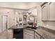 Modern kitchen with granite countertops and sleek black sink at 14124 W Bent Tree S Cir, Litchfield Park, AZ 85340