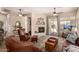Cozy living room with fireplace, ceiling fan, and sliding doors to backyard at 14124 W Bent Tree S Cir, Litchfield Park, AZ 85340
