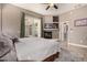Serene main bedroom with fireplace, ceiling fan, and sliding door to patio at 14124 W Bent Tree S Cir, Litchfield Park, AZ 85340