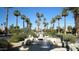Picturesque water feature is surrounded by desert landscaping, palm trees, and a well-maintained green space at 14124 W Bent Tree S Cir, Litchfield Park, AZ 85340