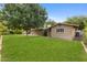 Great grassy backyard featuring large shade trees and beautiful landscaping, perfect for outdoor activities at 143 E Winter Dr, Phoenix, AZ 85020