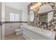 Bathroom with double vanity sinks, tile backsplash, and decorative mirrors at 143 E Winter Dr, Phoenix, AZ 85020