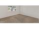 Clean bedroom with carpeted floors, white walls, and natural lighting at 143 E Winter Dr, Phoenix, AZ 85020