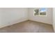 Simple bedroom with carpeted floors, white walls, and a single window at 143 E Winter Dr, Phoenix, AZ 85020