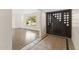 Inviting foyer with decorative tile flooring and a view into the light-filled living room with hardwood floors at 143 E Winter Dr, Phoenix, AZ 85020