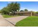 Charming single-story home with mature trees, a basketball hoop, and well-maintained front yard at 143 E Winter Dr, Phoenix, AZ 85020