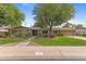 Beautiful home with mature trees and landscaping, enhancing the curb appeal at 143 E Winter Dr, Phoenix, AZ 85020