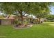 Beautiful home with mature trees and landscaping, enhancing the curb appeal at 143 E Winter Dr, Phoenix, AZ 85020