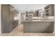 Contemporary kitchen featuring sleek cabinetry, a spacious island, modern appliances, and pendant lighting at 143 E Winter Dr, Phoenix, AZ 85020