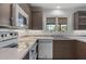 Well-lit kitchen showcasing stainless steel appliances, mosaic tile backsplash, and modern cabinetry at 143 E Winter Dr, Phoenix, AZ 85020