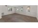 Living room with neutral carpet, wainscotting, and multiple windows offering natural light at 143 E Winter Dr, Phoenix, AZ 85020
