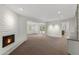 Large living room featuring a brick fireplace, open layout, and access to the outdoor area at 143 E Winter Dr, Phoenix, AZ 85020
