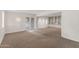 Open living room with neutral decor, built-in shelving, and access to an outdoor patio at 143 E Winter Dr, Phoenix, AZ 85020