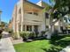 Charming condo building with a well-maintained lawn, mature trees, and desert landscaping at 145 N 74Th St # 125, Mesa, AZ 85207