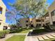 Landscaped walkway through condominium complex with mature trees providing shade and greenery at 145 N 74Th St # 125, Mesa, AZ 85207