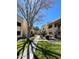Green lawns and mature trees line a walkway through condominium complex in a park-like setting at 145 N 74Th St # 125, Mesa, AZ 85207