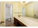 This bathroom features a long vanity, mirror, and a view of a bath and toilet at 1562 W Las Palmaritas Dr, Phoenix, AZ 85021