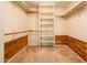 Walk-in closet with custom wood details and built in shelving offers storage solutions at 1562 W Las Palmaritas Dr, Phoenix, AZ 85021