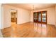 Dining room view with hardwood floors, chandelier, and pool view through French doors at 1562 W Las Palmaritas Dr, Phoenix, AZ 85021