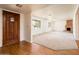 Foyer view leading into a carpeted living space with a fireplace, showcasing the entry door and windows at 1562 W Las Palmaritas Dr, Phoenix, AZ 85021