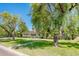Charming single story home featuring mature landscaping, green shutters and a brick facade at 1562 W Las Palmaritas Dr, Phoenix, AZ 85021