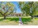 Charming single story home featuring mature landscaping, green shutters and a brick facade at 1562 W Las Palmaritas Dr, Phoenix, AZ 85021