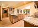 Open kitchen with a large island, stainless steel appliances and hardwood floors throughout at 1562 W Las Palmaritas Dr, Phoenix, AZ 85021