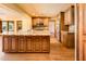 Bright kitchen featuring a large island with granite countertops, hardwood floors and views to the backyard at 1562 W Las Palmaritas Dr, Phoenix, AZ 85021