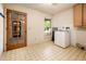 Laundry room with tile floors and a window at 1562 W Las Palmaritas Dr, Phoenix, AZ 85021