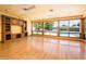 Bright living room features hardwood floors, built-in cabinets, and large windows overlooking the backyard pool at 1562 W Las Palmaritas Dr, Phoenix, AZ 85021