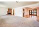 Large living area features a brick fireplace, carpeted flooring, and an open layout at 1562 W Las Palmaritas Dr, Phoenix, AZ 85021