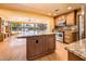Open concept living space featuring a large kitchen island and views of the backyard pool at 1562 W Las Palmaritas Dr, Phoenix, AZ 85021