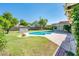 Refreshing backyard pool with a spacious concrete patio and lush lawn for outdoor activities and leisure at 1562 W Las Palmaritas Dr, Phoenix, AZ 85021