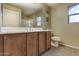A clean bathroom showcases a double vanity with a large mirror, a bathtub and window at 16525 E Avenue Of The Fountain -- # 113, Fountain Hills, AZ 85268