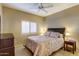 Bedroom boasts a ceiling fan, window with shutters, and a comfortable queen-sized bed at 16525 E Avenue Of The Fountain -- # 113, Fountain Hills, AZ 85268