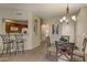 Well-lit dining area features a round table, tiled flooring, and views into the kitchen with barstool seating at 16525 E Avenue Of The Fountain -- # 113, Fountain Hills, AZ 85268