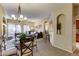 Bright dining area with a glass-top table, chandelier, and an open view into the comfortable living space at 16525 E Avenue Of The Fountain -- # 113, Fountain Hills, AZ 85268