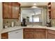 Kitchen view featuring wood cabinets and a pass-through window to living room at 16525 E Avenue Of The Fountain -- # 113, Fountain Hills, AZ 85268