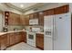 Well-lit kitchen features wood cabinets, white appliances, and ample counter space at 16525 E Avenue Of The Fountain -- # 113, Fountain Hills, AZ 85268