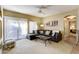 Comfortable living room with a plush sectional sofa, neutral carpet, and sliding doors to the outdoor area at 16525 E Avenue Of The Fountain -- # 113, Fountain Hills, AZ 85268