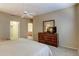 Cozy main bedroom with a large bed, dresser, and doorway to an ensuite bathroom and walk in closet at 16525 E Avenue Of The Fountain -- # 113, Fountain Hills, AZ 85268