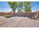 Spacious backyard features a trampoline, chairs, pavers, and gravel, perfect for outdoor activities and relaxation at 16887 W Belleview St, Goodyear, AZ 85338