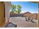 Large backyard features a stone design, several chairs, and a spacious area for Gathering fun at 16887 W Belleview St, Goodyear, AZ 85338