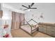 Charming bedroom features a tent bed, ceiling fan, and dresser, creating a cozy and inviting atmosphere at 16887 W Belleview St, Goodyear, AZ 85338
