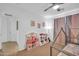 Bright bedroom with a tent bed, play kitchen, and ample space for play, perfect for a imaginative adventures at 16887 W Belleview St, Goodyear, AZ 85338