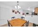 Well-lit dining area featuring a wooden table, seating, and easy access to the kitchen at 16887 W Belleview St, Goodyear, AZ 85338