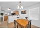 Bright dining area with a wooden table, chairs, and an adjacent kitchen, perfect for Gathering meals at 16887 W Belleview St, Goodyear, AZ 85338